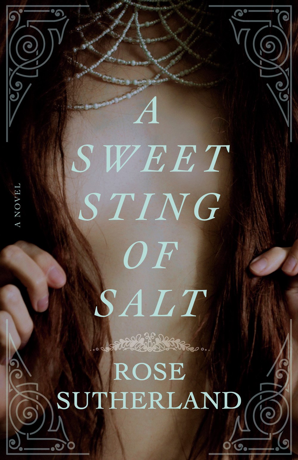 A book cover depicting the center of a woman's bare chest, framed by long dark hair.